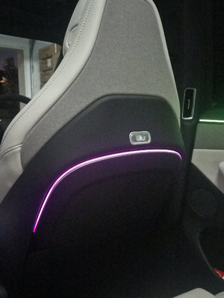 Tesla electric folding table with LED lighting and wireless charging pad installed in Model Y Juniper rear cabin