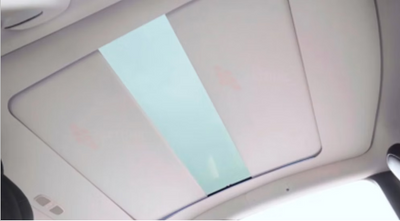 Car sunshade on a car's sunroof partly open with a white background #myteslaaccessoriesau