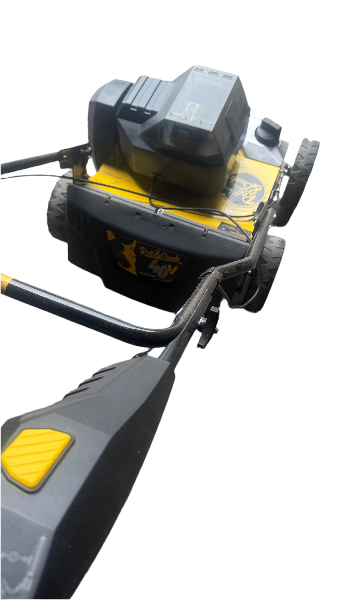 Garland 602W battery lawn sweeper in action on synthetic turf - professional-grade cleaning