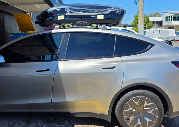 Original without background removed of Roof racks installed on a Tesla Model YL with a Pod on top.