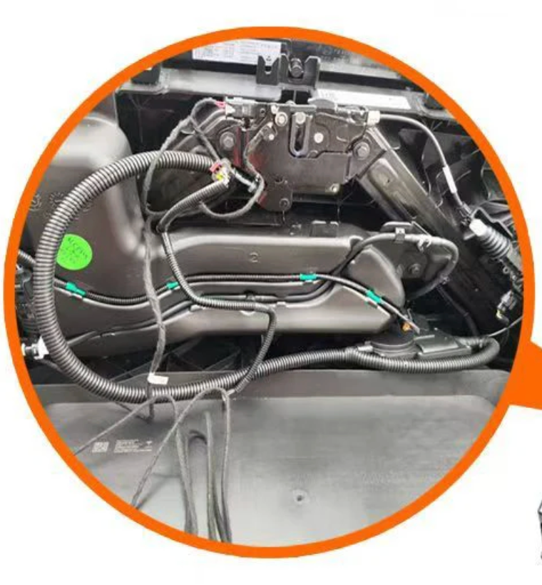 Close-up of car soft close bracket with wiring and mechanical components.