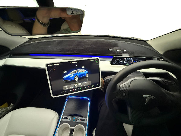 Tesla car interior with dashboard mat, touchscreen display and swivel screen