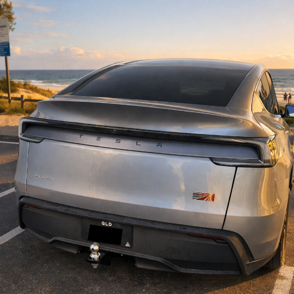 Tesla Model Y YL parked by the beach at sunset with tow bar for the  YL Tesla on show